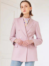 a woman in pink blazer